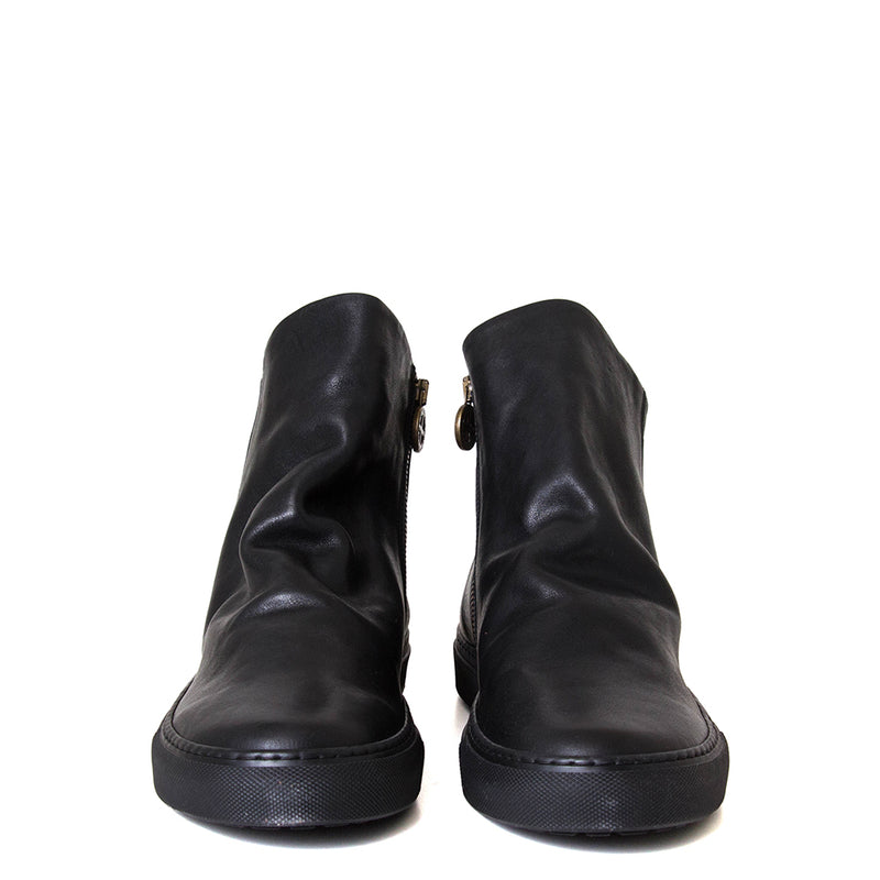 Pair of black leather ankle boots on a white background