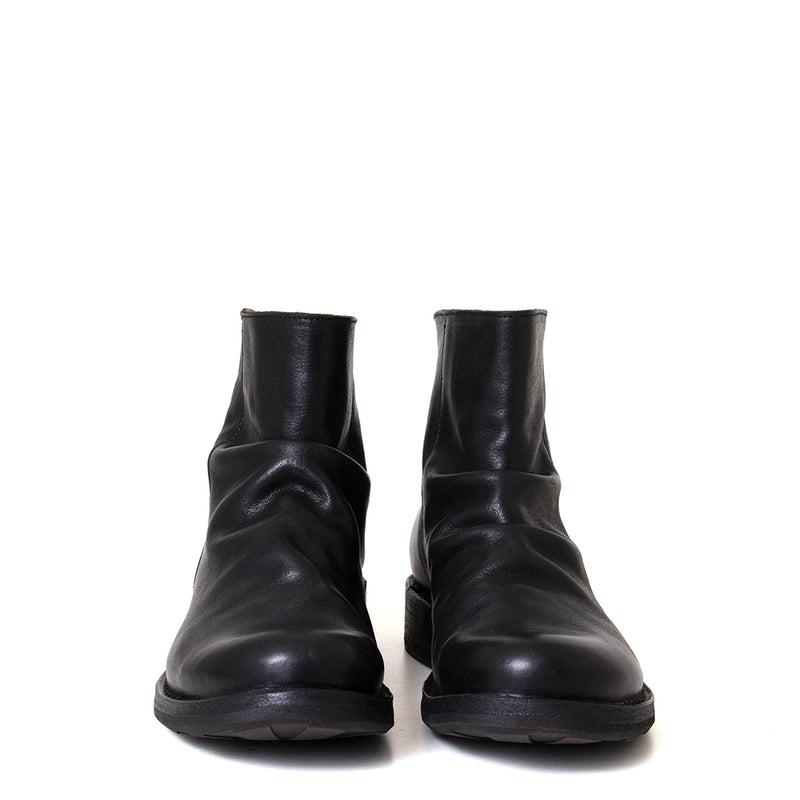 Pair of black leather boots on a white background