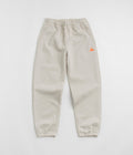 Nike ACG Tuff Fleece Lungs Pants in Light Orewood Brown and Hyper Crimson