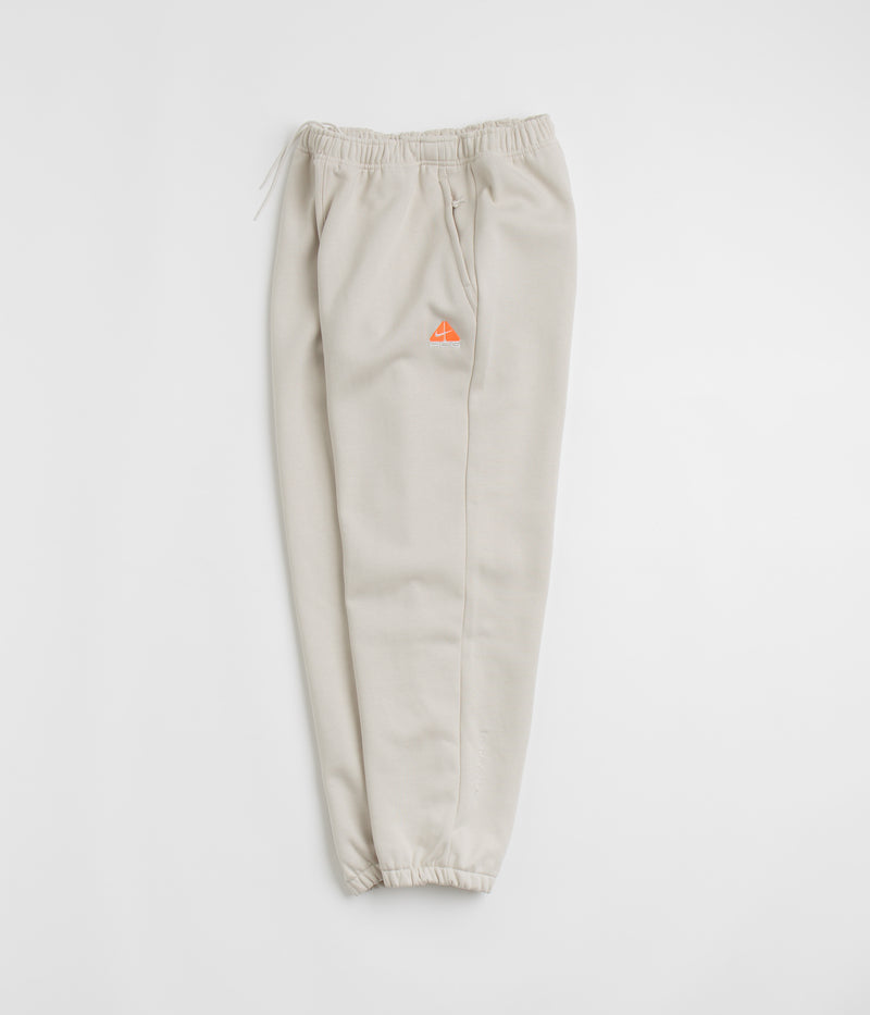 Nike ACG Tuff Fleece Lungs Pants in Light Orewood Brown and Hyper Crimson