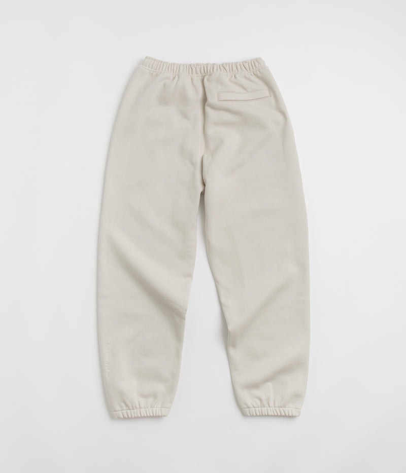 Nike ACG Tuff Fleece Lungs Pants in Light Orewood Brown and Hyper Crimson