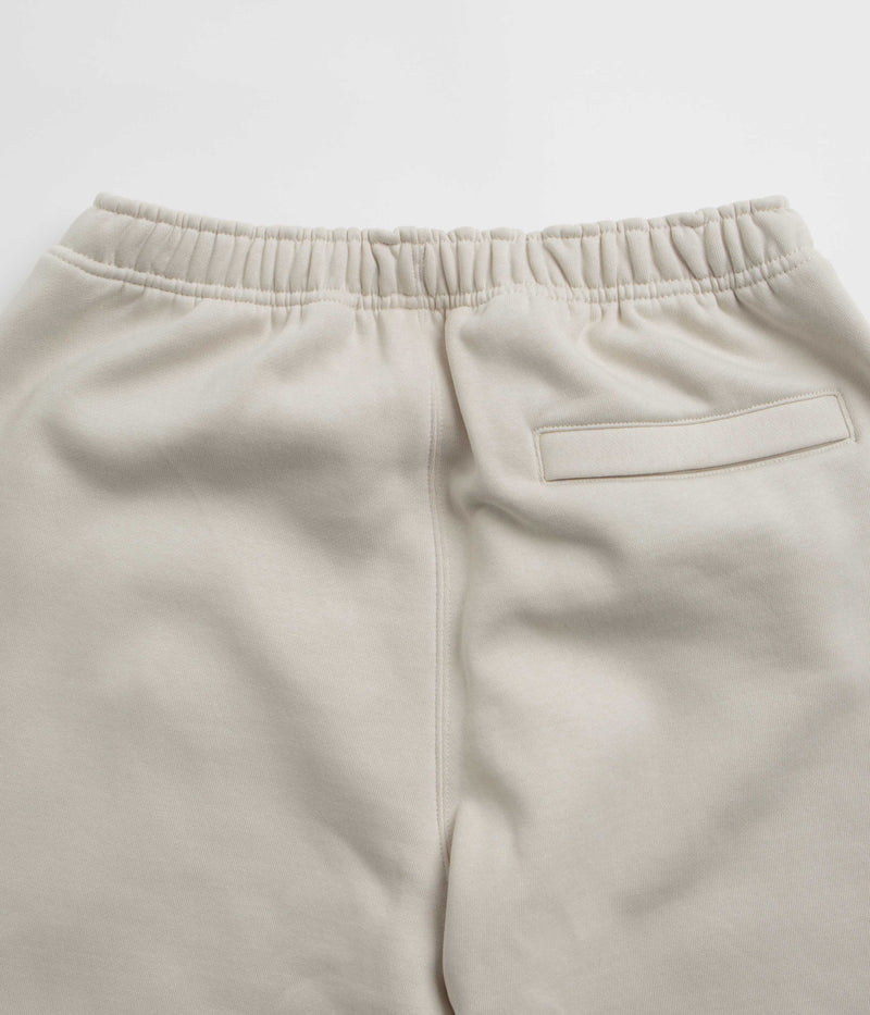Nike ACG Tuff Fleece Lungs Pants in Light Orewood Brown and Hyper Crimson