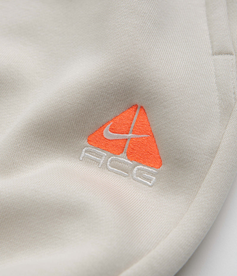 Nike ACG Tuff Fleece Lungs Pants in Light Orewood Brown and Hyper Crimson