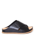 Kork-Ease Tutsi Cross-Band. Women's slide sandals in black criss-cross leather straps. Cushioned anatomical cork footbed for comfort and arch support. 1-inch flat heel. Side view.